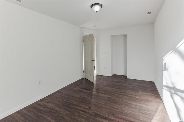 unfurnished bedroom with dark hardwood / wood-style flooring