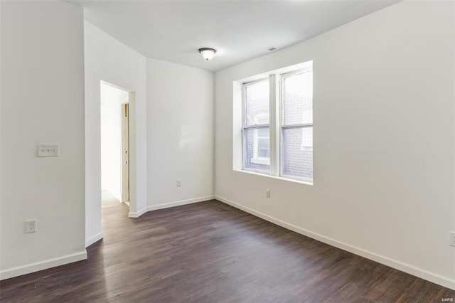 unfurnished room featuring dark hardwood / wood-style flooring