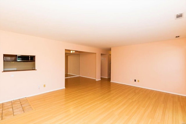 empty room with hardwood / wood-style floors