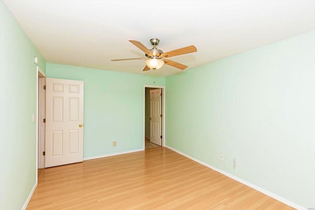 spare room featuring light hardwood / wood-style flooring and ceiling fan