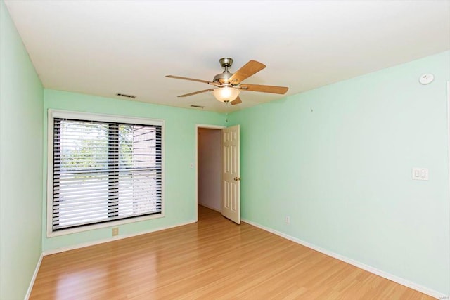 unfurnished room with ceiling fan and light hardwood / wood-style floors