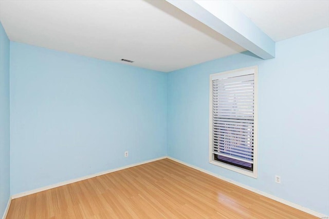 unfurnished room with wood-type flooring