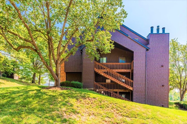 exterior space featuring a lawn and a deck