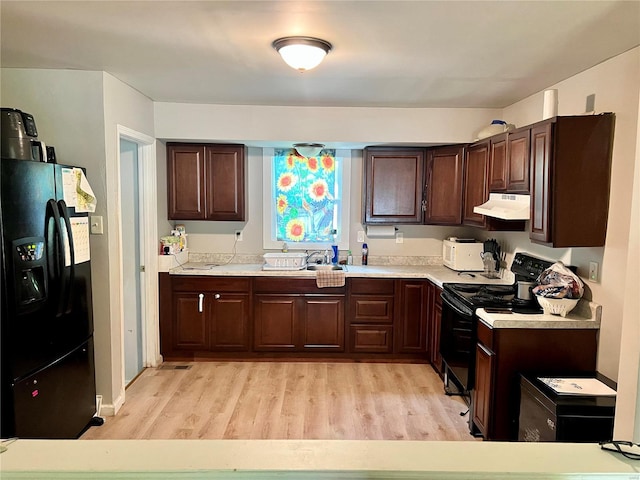 kitchen featuring light hardwood / wood-style floors, black refrigerator with ice dispenser, exhaust hood, dark brown cabinets, and stainless steel electric range oven