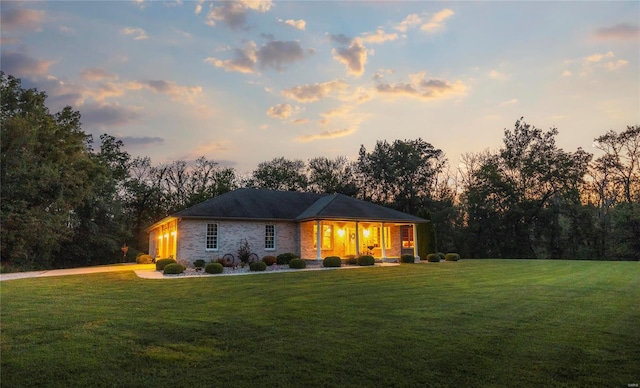 single story home featuring a yard