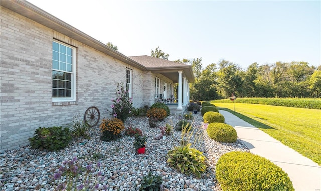 view of home's exterior featuring a yard and covered porch