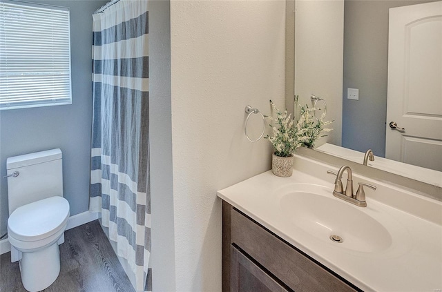 bathroom featuring vanity, a shower with shower curtain, wood-type flooring, and toilet