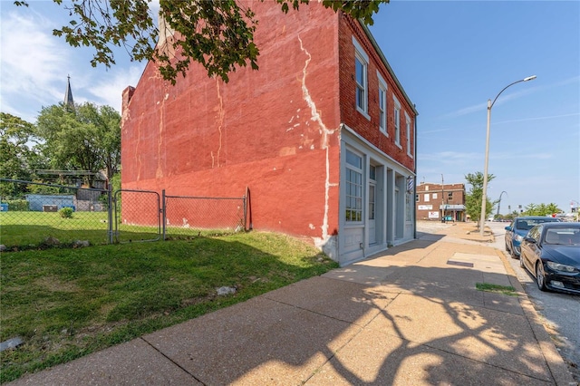 view of property exterior with a lawn