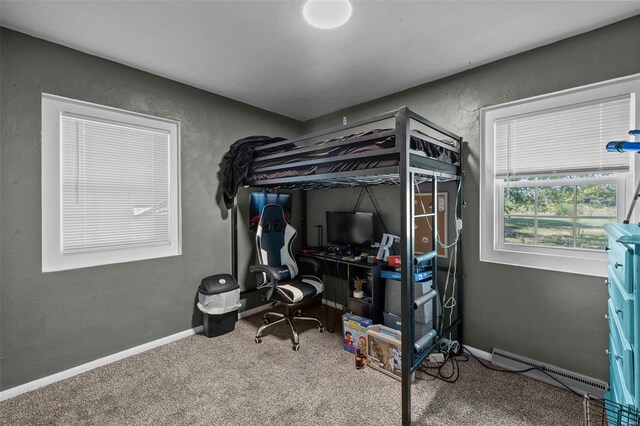 carpeted bedroom with a baseboard heating unit