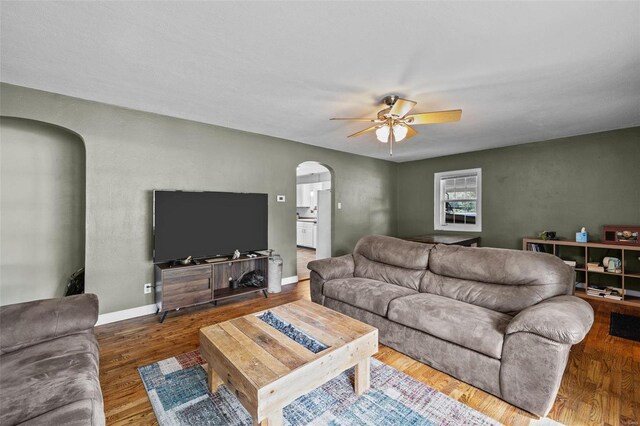 living room with hardwood / wood-style flooring and ceiling fan