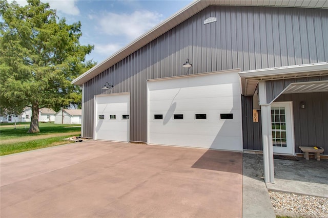 garage with a lawn and wooden walls