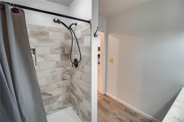 bathroom featuring walk in shower and wood-type flooring