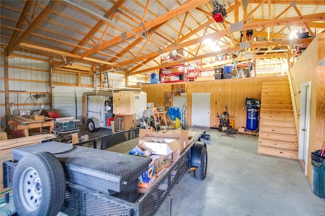 garage featuring wood walls and a workshop area