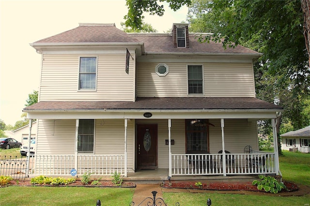 view of front of house featuring a front yard and a porch