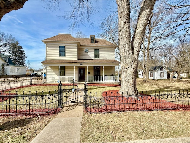 view of front of home with a fenced front yard, covered porch, and a gate