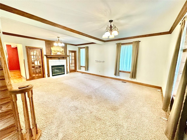 unfurnished living room featuring carpet floors, crown molding, and a notable chandelier