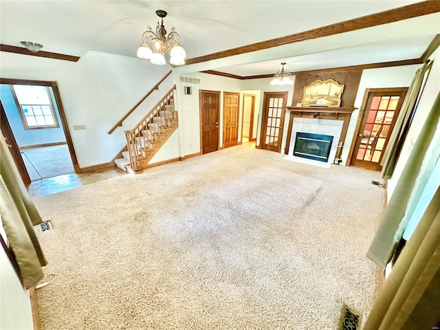 unfurnished living room with carpet, visible vents, a notable chandelier, and stairs