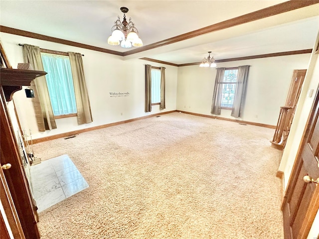 carpeted empty room featuring visible vents, crown molding, baseboards, and an inviting chandelier