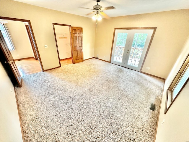 unfurnished bedroom with access to outside, french doors, visible vents, and light carpet