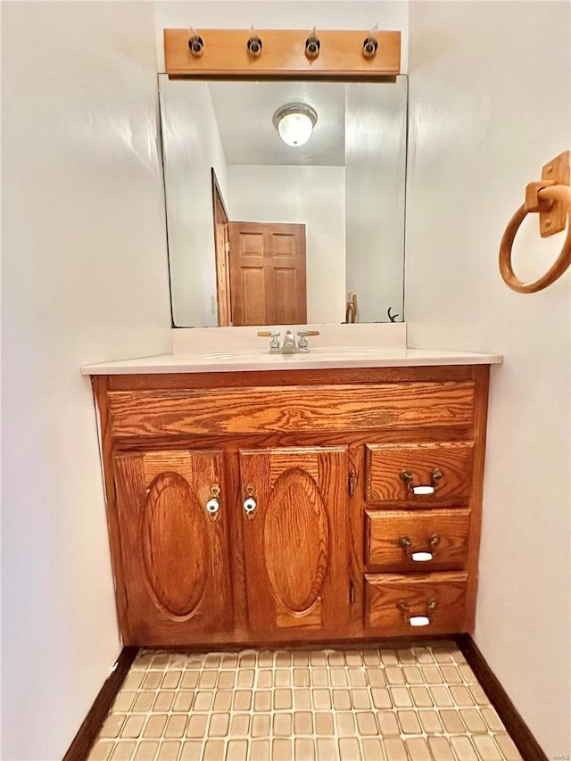 bathroom with vanity and baseboards