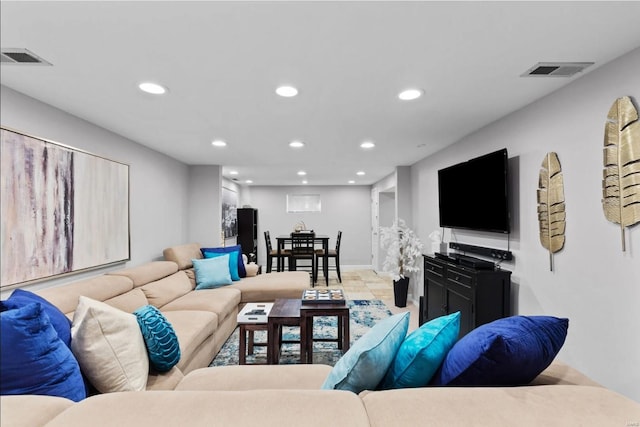 living area featuring baseboards, visible vents, and recessed lighting