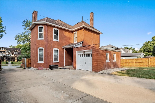 rear view of house featuring a garage