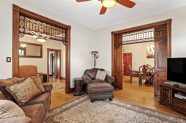 living room with ceiling fan and hardwood / wood-style flooring