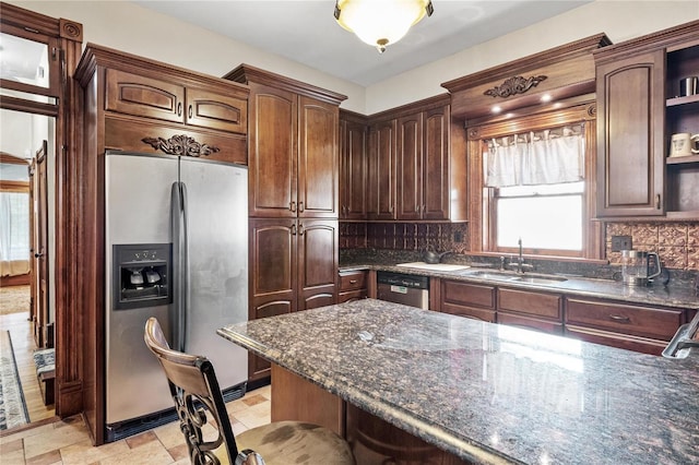 kitchen with decorative backsplash, dark brown cabinetry, sink, and appliances with stainless steel finishes