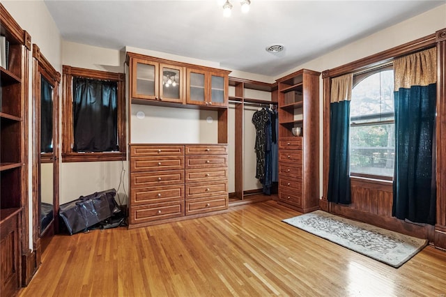 walk in closet with light wood-type flooring