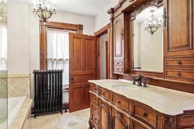 bathroom featuring tile patterned flooring, radiator heating unit, vanity, and tiled bath