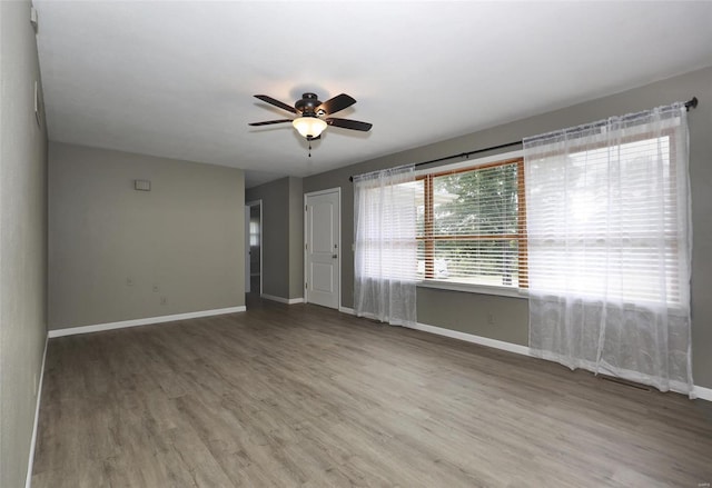 spare room featuring light hardwood / wood-style flooring and ceiling fan