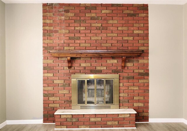 interior details featuring hardwood / wood-style floors and a fireplace