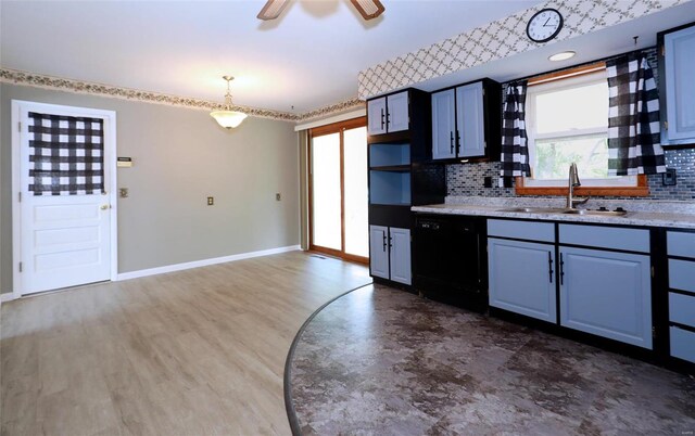 kitchen featuring black dishwasher, a wealth of natural light, sink, and ceiling fan