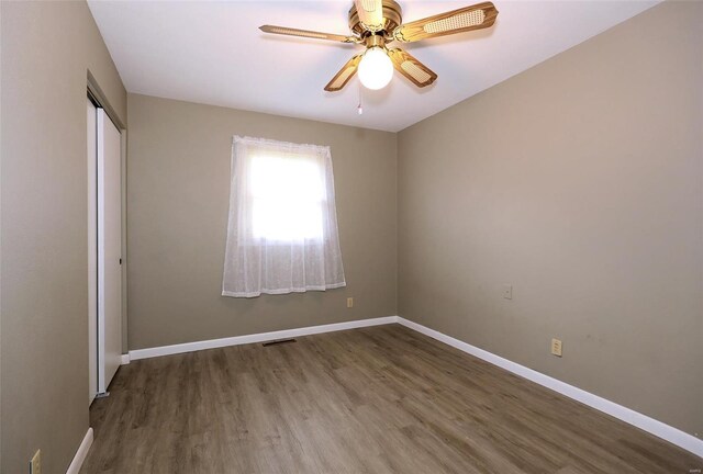 empty room with hardwood / wood-style floors and ceiling fan