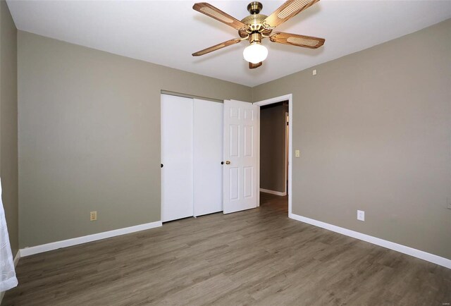 unfurnished bedroom with hardwood / wood-style floors, ceiling fan, and a closet