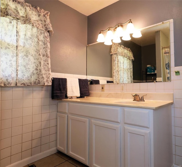 bathroom with vanity, tile walls, and tasteful backsplash