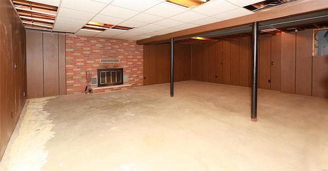 basement with wood walls and a fireplace