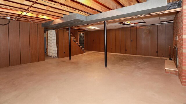 basement featuring wood walls