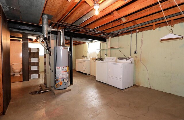 basement featuring gas water heater and washing machine and clothes dryer