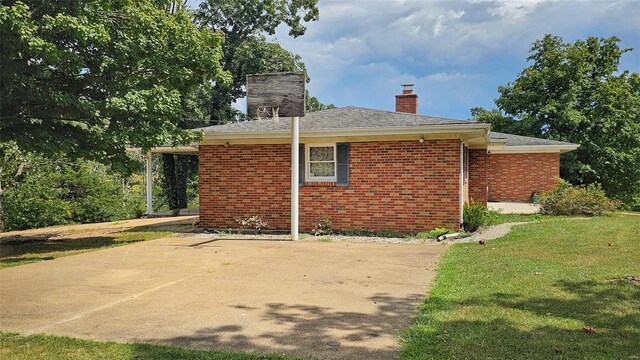 rear view of property featuring a yard