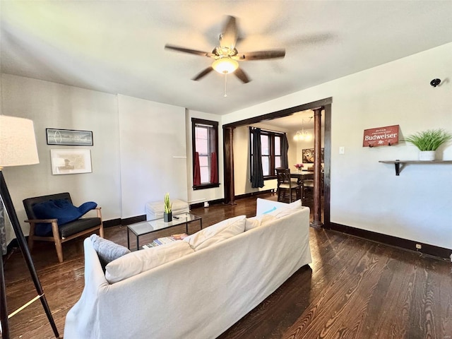 living room featuring ceiling fan and dark hardwood / wood-style flooring