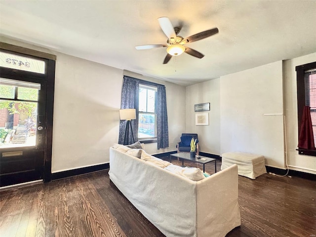 living room with ceiling fan and dark hardwood / wood-style floors