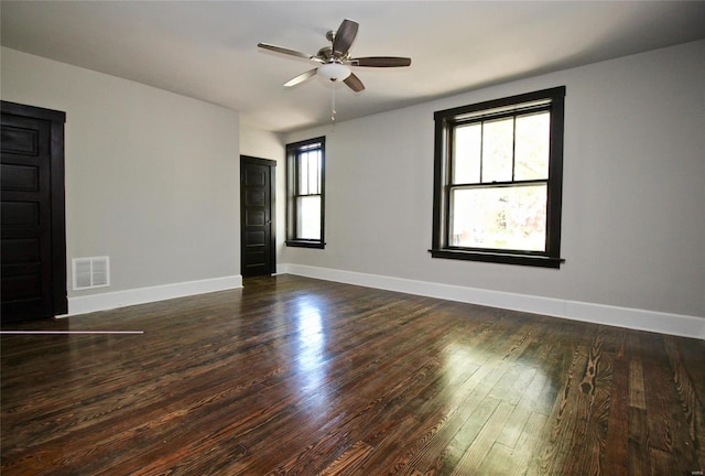 unfurnished room featuring dark wood-type flooring and ceiling fan