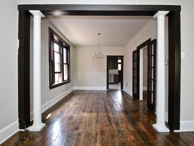 unfurnished dining area with dark hardwood / wood-style flooring and an inviting chandelier