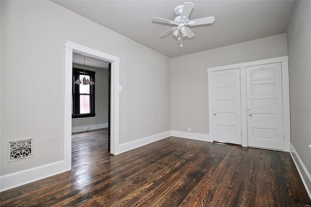 unfurnished bedroom featuring dark hardwood / wood-style floors, a closet, and ceiling fan