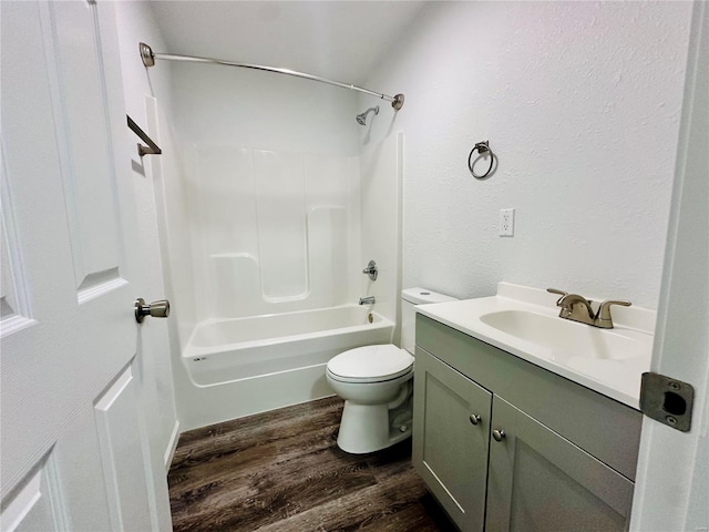 full bathroom featuring shower / washtub combination, hardwood / wood-style floors, vanity, and toilet