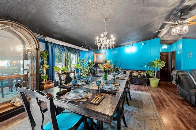 dining area with a textured ceiling, vaulted ceiling, wood finished floors, and ceiling fan with notable chandelier