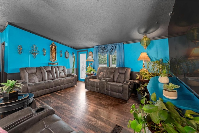 living room featuring a textured ceiling, wood finished floors, and wainscoting