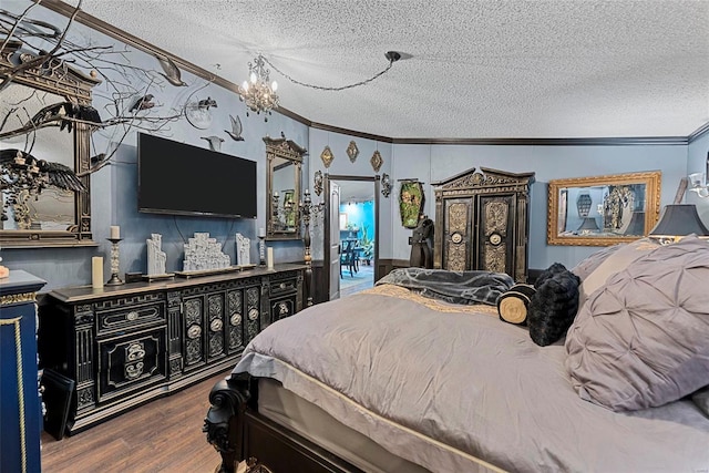 bedroom with a textured ceiling, a chandelier, wood finished floors, and crown molding