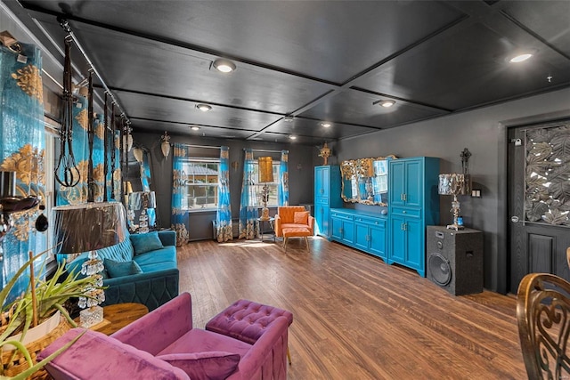 living area featuring recessed lighting, coffered ceiling, and wood finished floors